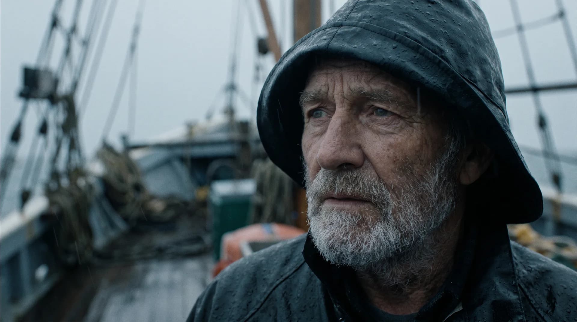 Cinematic portrait of a weathered fisherman in the rain